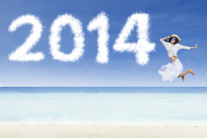 Woman jumping with clouds of 2014